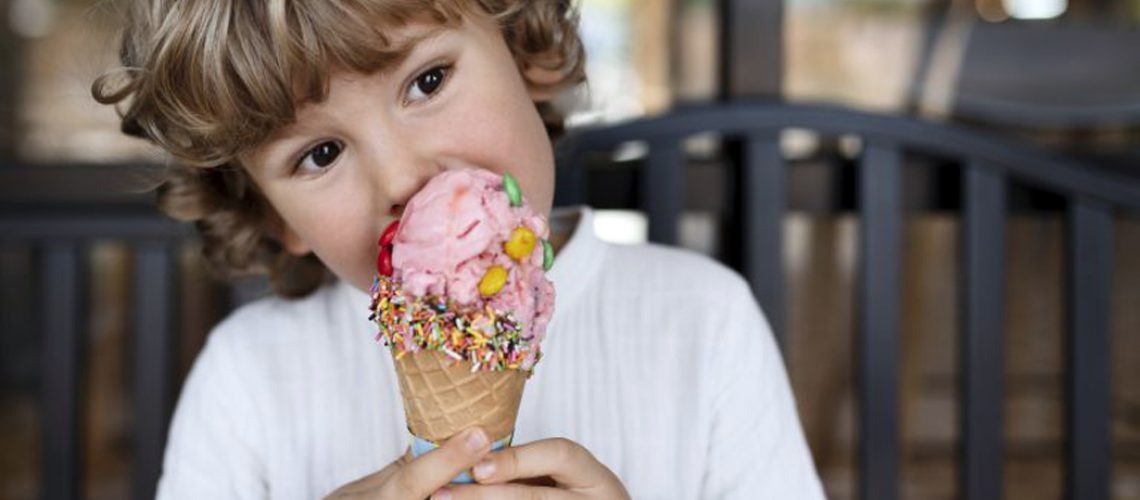 front-view-little-boy-eating-ice-cream-768x512